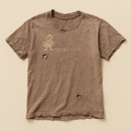 Dusty taupe t-shirt with a faded cartoon mascot and worn lettering on the chest — flat lay