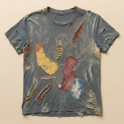 Slate t-shirt repaired by hand with mismatched patches and visible sashiko stitching — flat lay